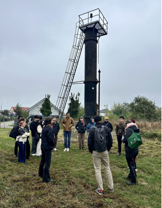 People gathered around a metal tower